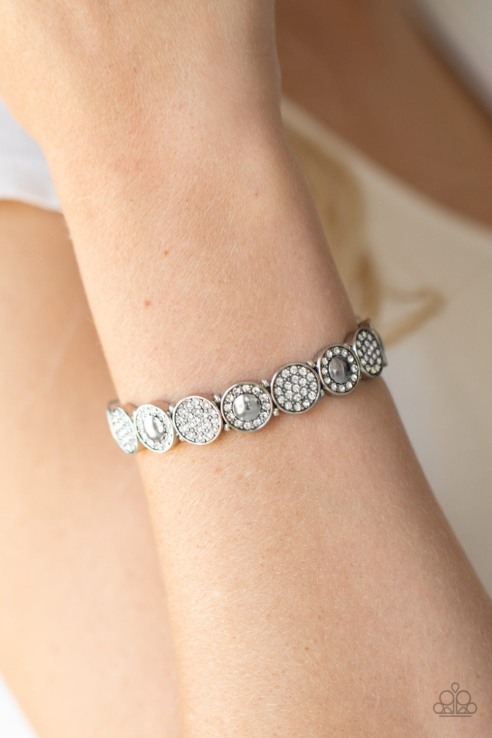 Paparazzi Encrusted in dainty white rhinestones, mismatched silver frames are threaded along stretchy bands around the wrist for a sparkly look.