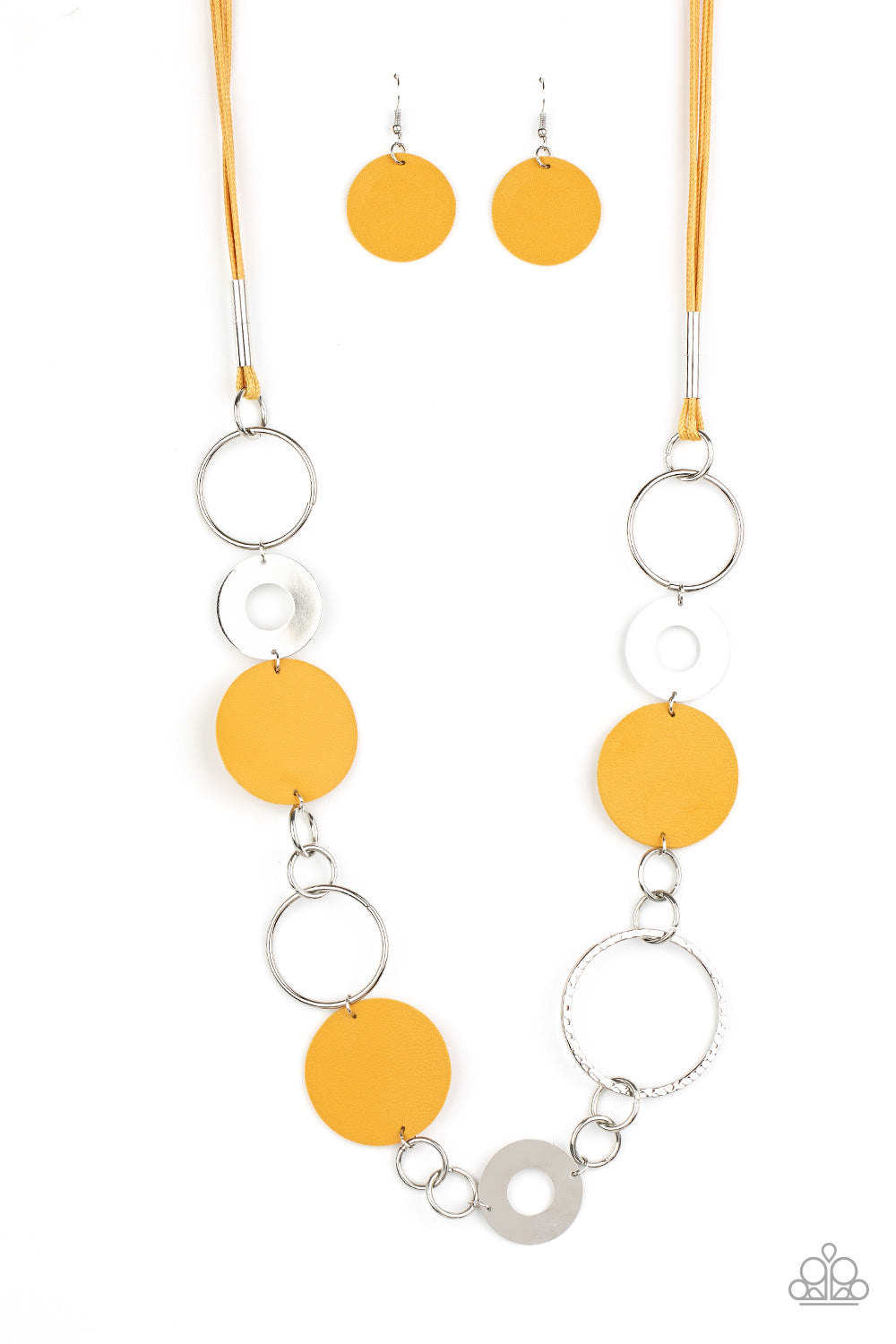 A shiny collection of mismatched silver rings and textured hoops link with round pieces of yellow leather across the chest for a whimsically earthy look.