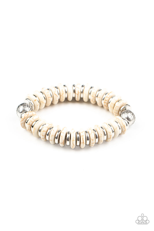 Infused with a pair of ornate silver beads, an earthy collection of shiny silver and refreshing white stone discs alternate along a stretchy band around the wrist for an authentically artisan inspired look.